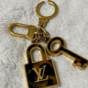 Louis Vuitton lock and key bag charm. Includes box and dust bag.